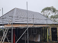 After — New grey slate roof on garage extension