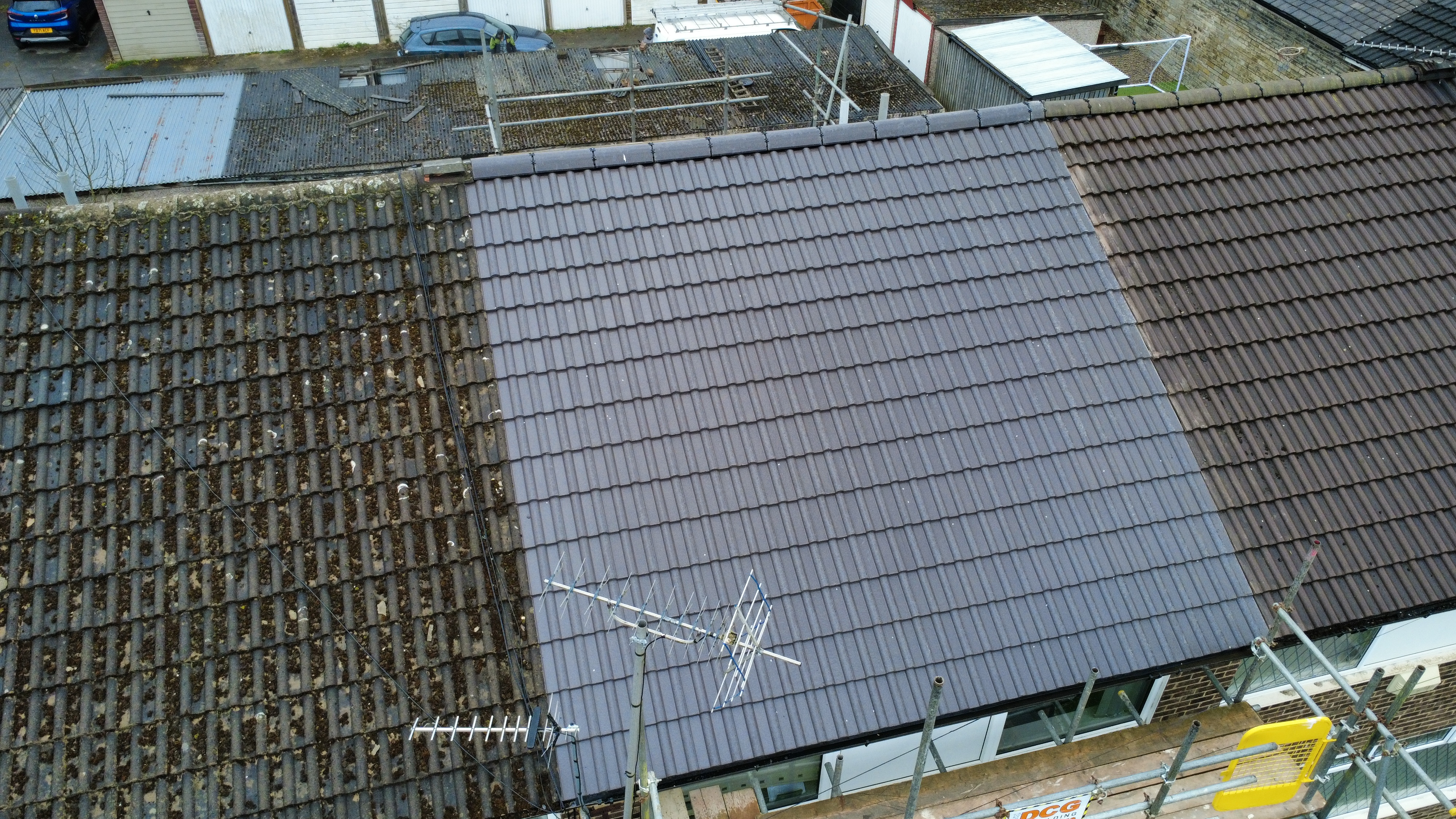 Aerial drone photo of a Bradford terraced house showing a newly tiled roof side-by-side with the weathered original — full re-roof by Leafield Roofing in Eccleshill BD2