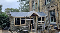 Front porch extension under construction in Bradford, new timber roof structure and slate installation in progress by Leafield Roofing