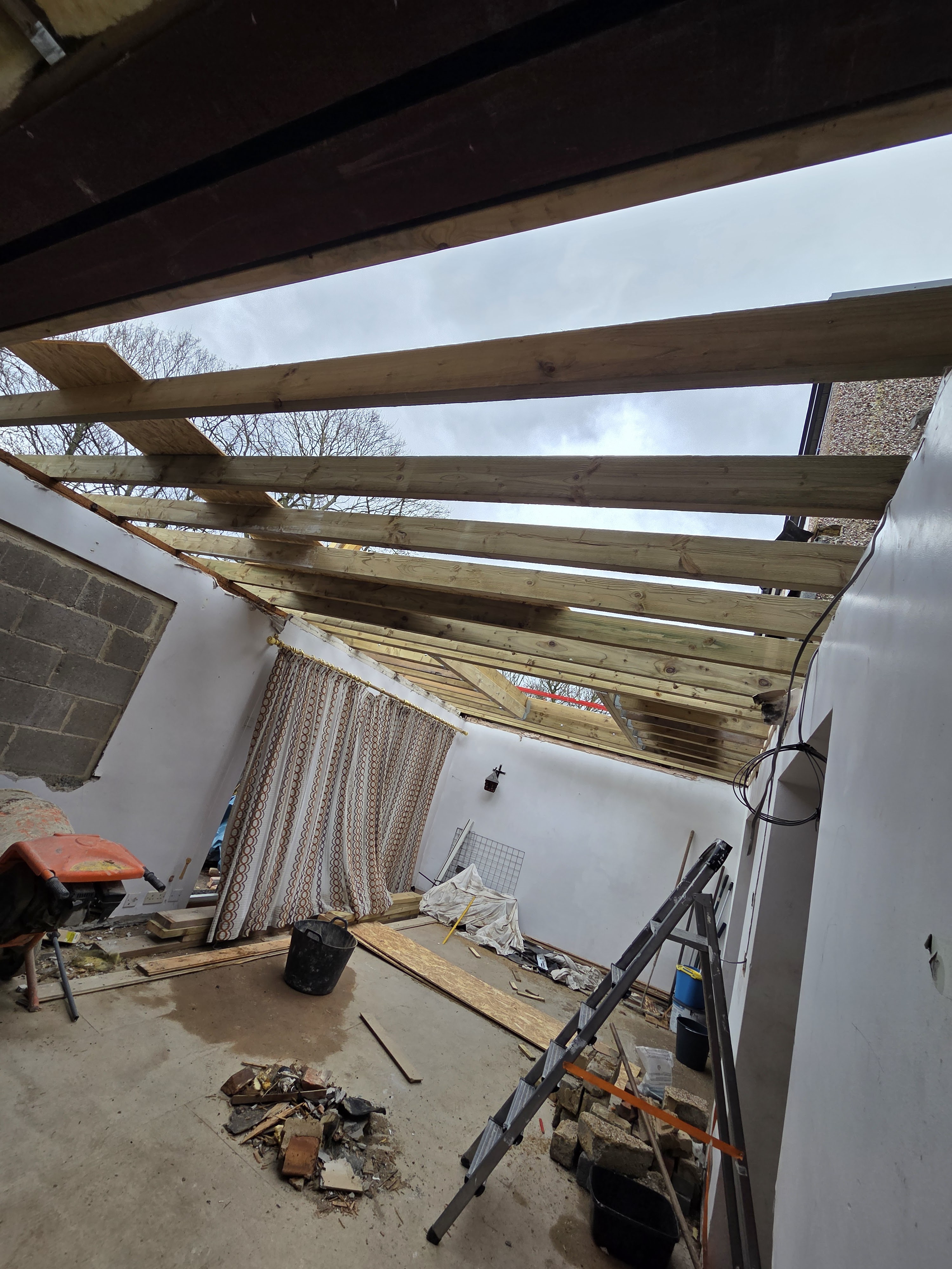 Interior view of new roof frame over a rear extension during build, Bradford — ready for felt, batten and slate by Leafield Roofing