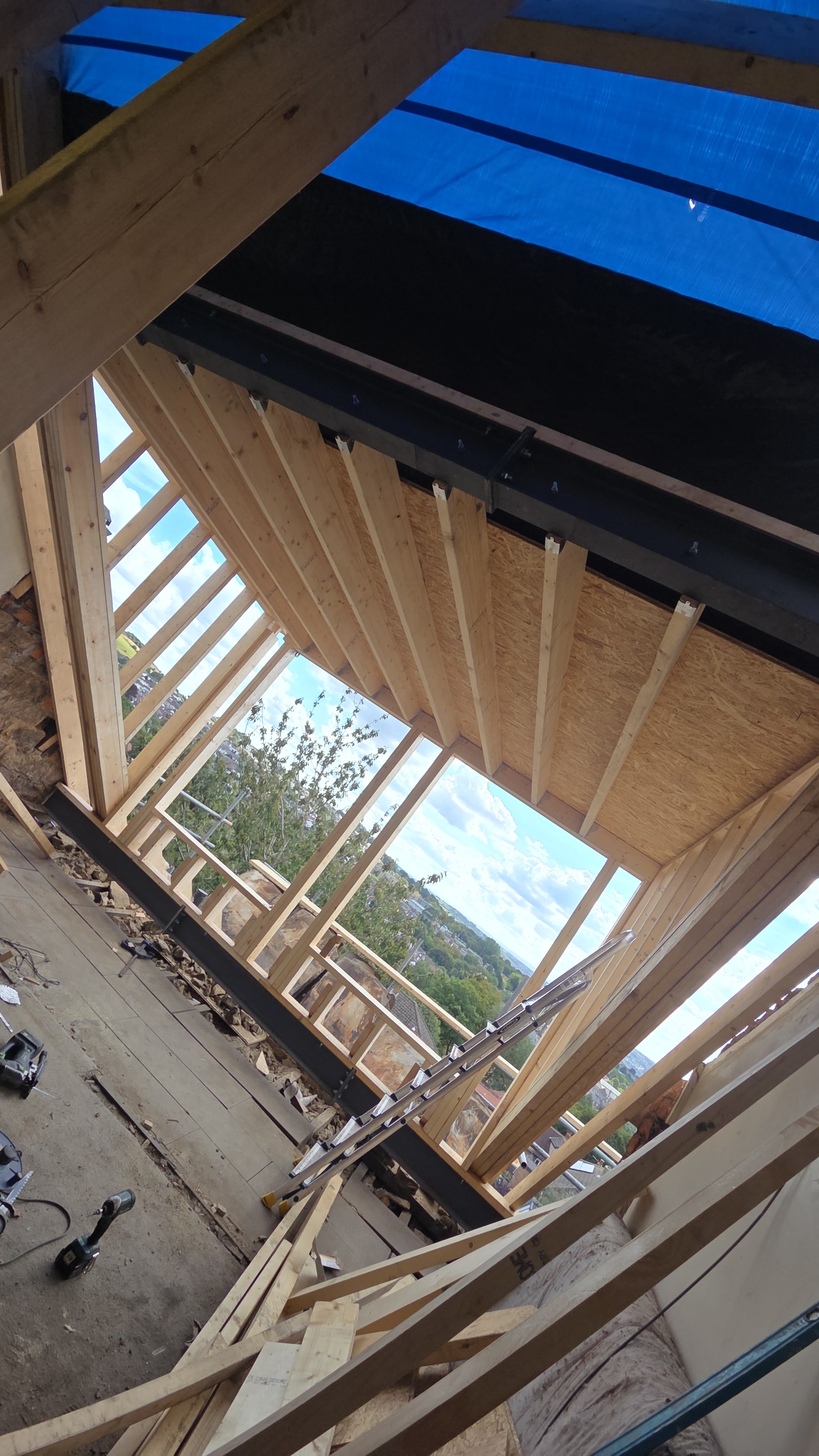 Loft-conversion interior in Bradford showing inserted structural steel beam and new timber frame — Building-Reg compliant work by Leafield Roofing